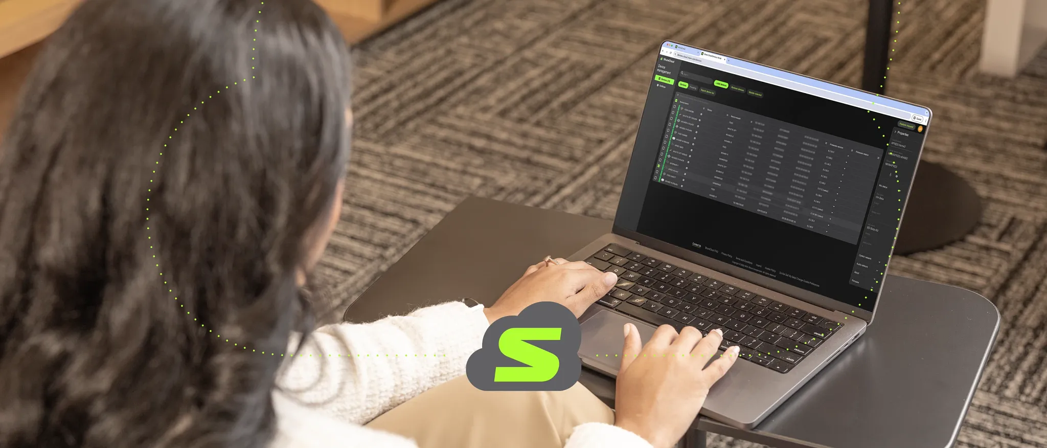 Technician using the ShureCloud device management dashboard on a laptop