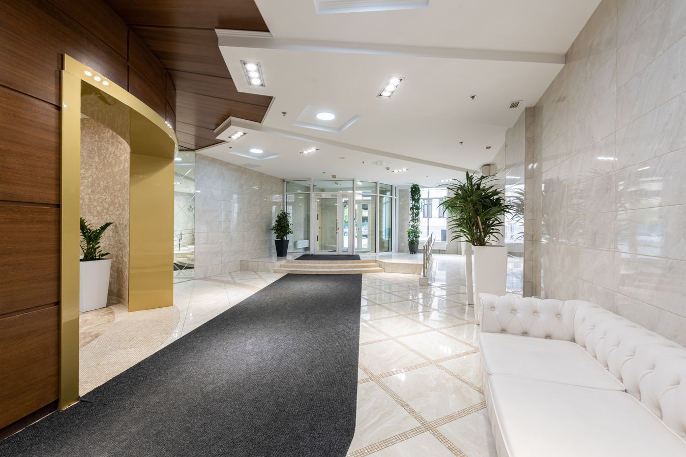 Spacious modern hotel lobby with several seating and circulation zones